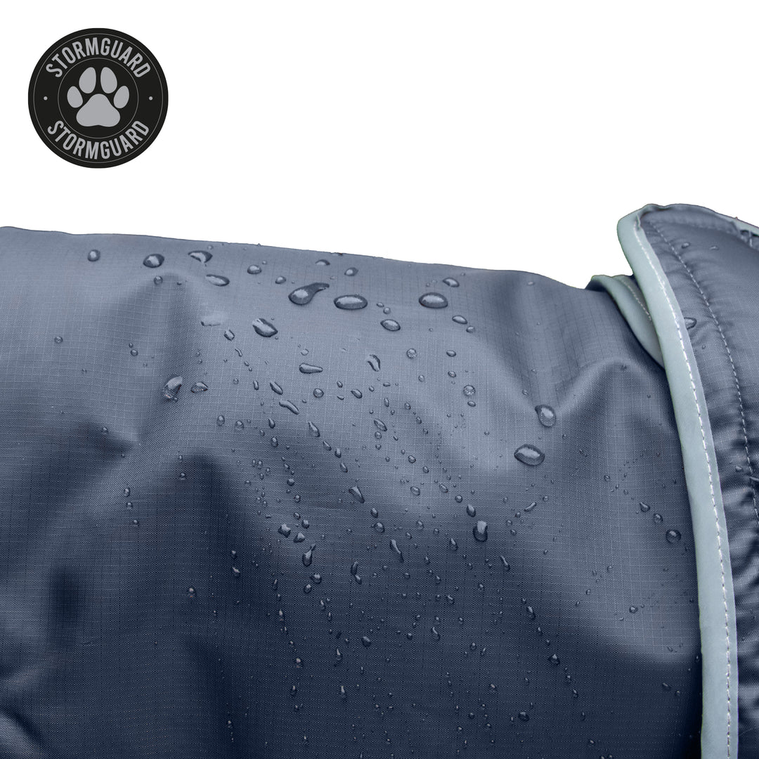 Close up of water beading on the waterproof outer of the Ancol Stormguard navy dog coat