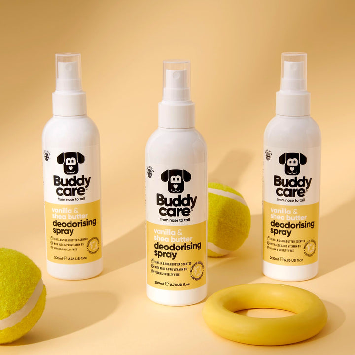 Three bottles of Buddycare Vanilla and Shea Butter Dog Deodorising Spray with tennis balls