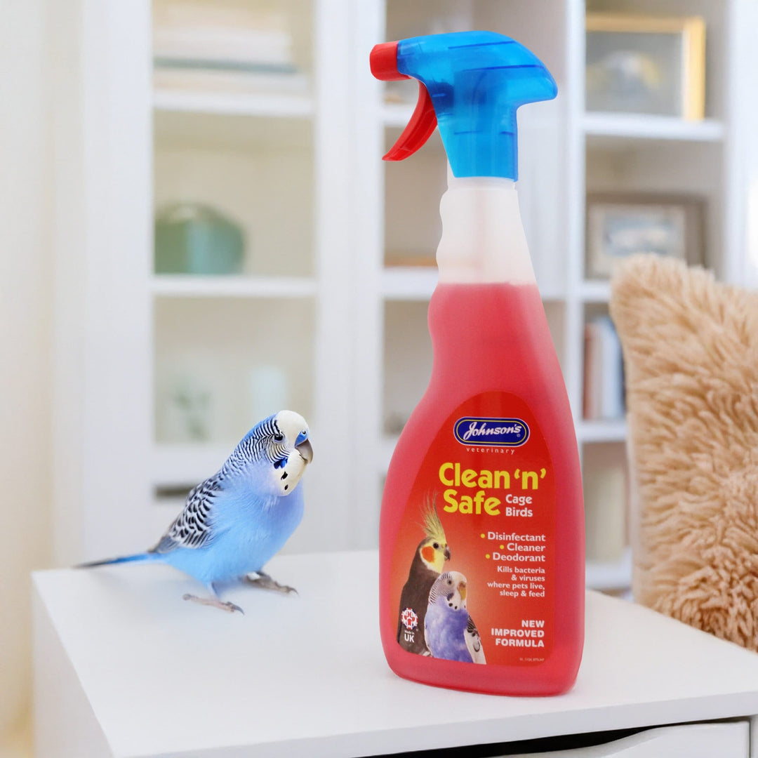 Johnson's Clean 'n' Safe bird disinfectant spray beside a budgie